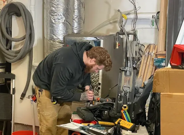Technician working at a bench in a utility room