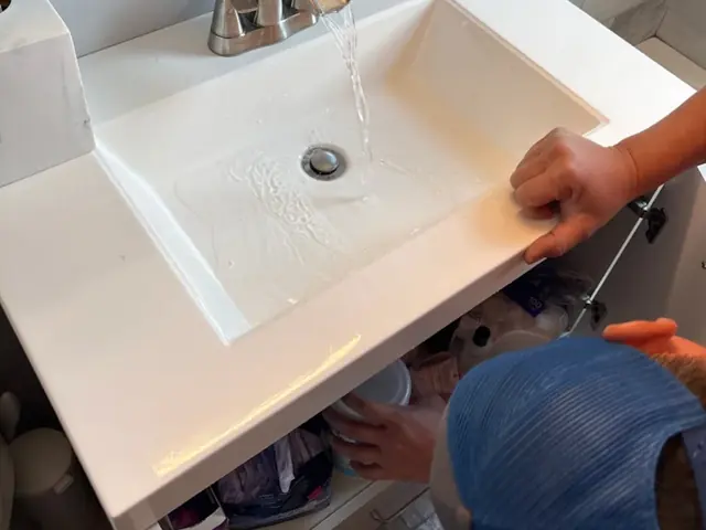 Plumber testing a newly fixed bathroom sink