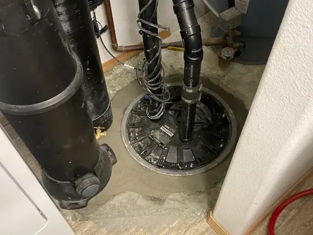 New sealed sump pump basin set in fresh concrete